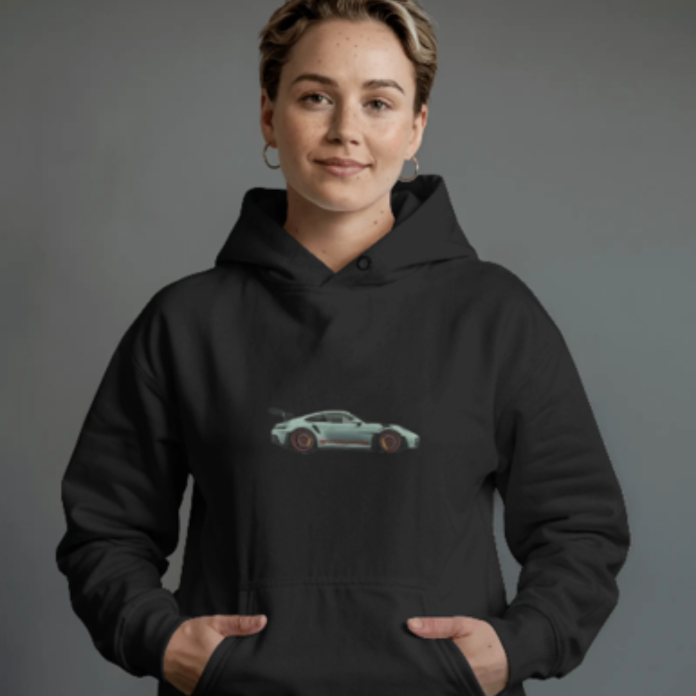 A woman wearing a black hoodie with a centered minimalist graphic of a sleek sports car in a side profile view. The background is neutral grey, and she has a confident, subtle smile.