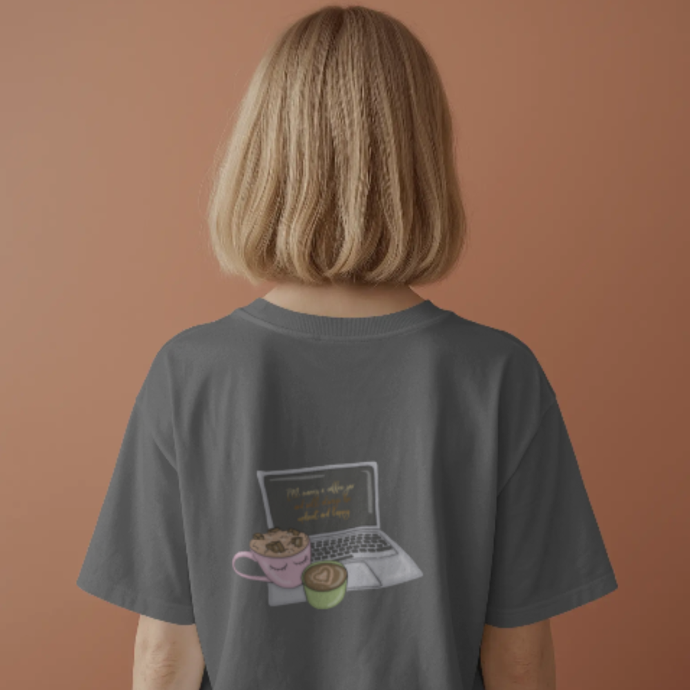 A person wearing a charcoal grey T-shirt with a back graphic of a laptop and two cute coffee mugs (one with whipped cream, one with latte art). The screen displays a quote that reads, “Put some coffee on and handle it all, honey.”